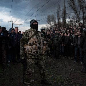 Masked pro-Russian fighters supported by the crowd disarm Ukrainian Army convoy near Pchelkino village, East Ukraine 