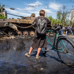 Crowd is watching the wreck of an Ukrainian Army light tank in Mariupol