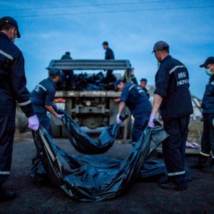 Rescue workers load the bodies of MH17 flight victims into the track near the village of Hrabove, East Ukraine