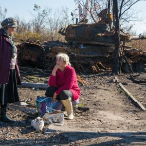 Locals are waiting for a bus by a tank wreck in Novosvetlovka village, Luhansk region. The village was nearly destroyed during the heavy fighting between insurgents and government troops