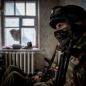 A serviceman of Ukrainian OUN volunteer battalion rests inside occupied house in the village of Peski, West of Donetsk.