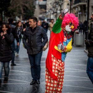 A clown tries to attract customers for a shop in central Baku.