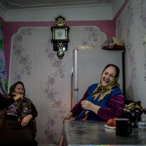 Nina (left) and Jovhar drink tea in a kitchen in the Alatava 2 district