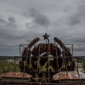 Soviet coat of arms sign on the roof of an abandoned apartment block in Pripyat, Ukraine