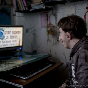 Denis Sviridenko,15, who was born without ears as a result of Chernobyl disaster plays a videogame on his computer