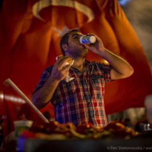 Pro-government supporter refreshes himself with a glass of ayran during the  celebrations of the failed coup attempt in Taksim square of Istanbul, Turkeyin Taksim square of Istanbul, Turkey