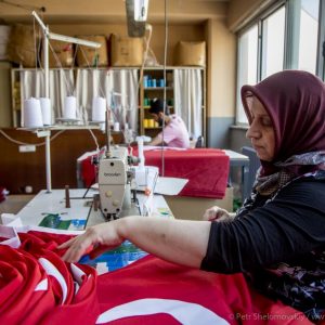 Flag factory worker is busy making another set of Turkish flags. The factory works 24x7 to supply growing demand. Istanbul, Turkey