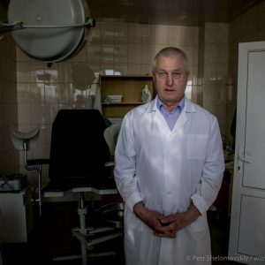 Viktor Khanaev a doctor and a city council member of Novozybkov in western Russia poses for a photograph at his workplace