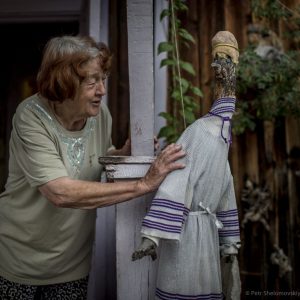 Prokopyev's wife Herolda with one of the pieces of driftwood she has made into characters around the property. In Soviet days, she worked as a cashier and radio operator at the airport.