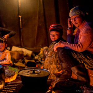 Yadne family members gather around open fire in their chum in the family herding camp on the left  bank of Yenisey river in West Siberia