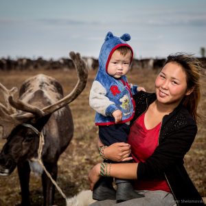 17 yo Nadezhda Yadne is posing for a picture with her 1.5 yo nephew Bogdan in the family herding camp on the left bank of Yenisey river in West Siberia