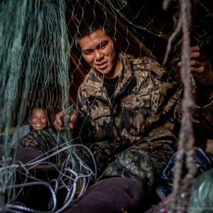 21 yo Nikolay Yadne is preparing fishing net in the family herding camp on the left bank of Yenisey river in West Siberia